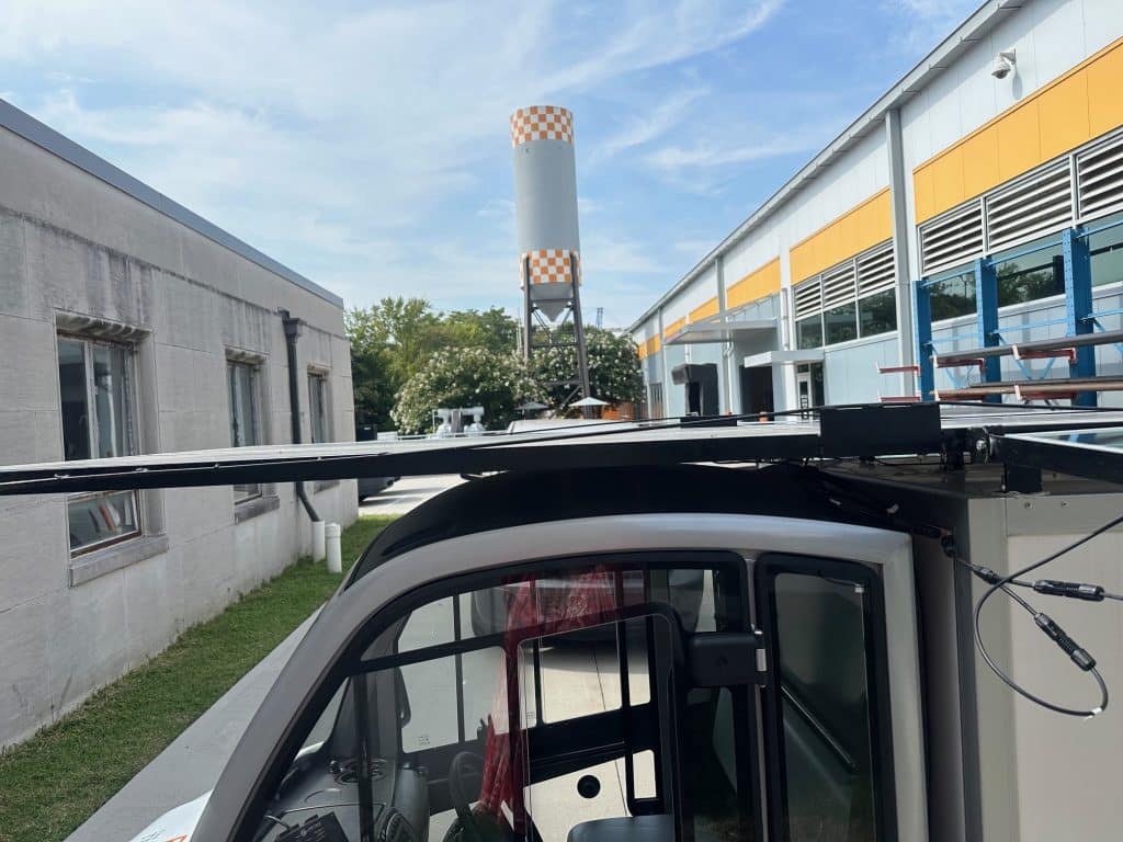 photo of solar panels on top of the Club Car parked outside of the Facilities Services Complex