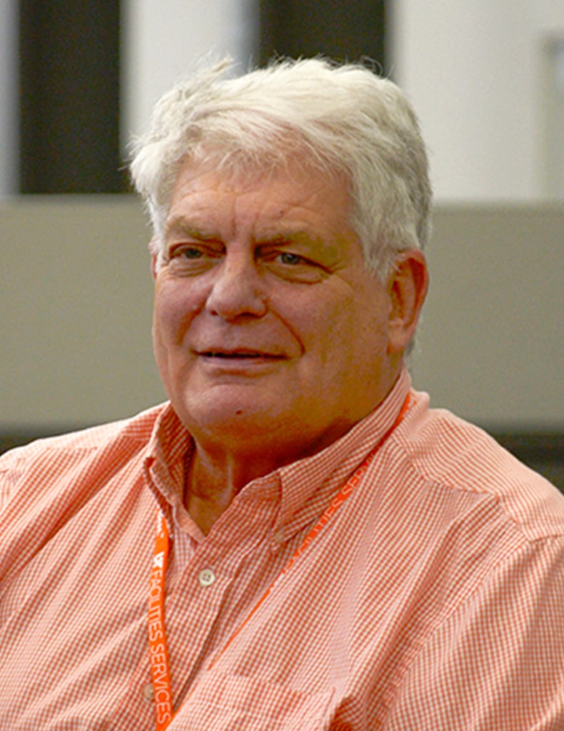 image of Gordon Nelson, director of Building Services, wearing an orange gingham shirt