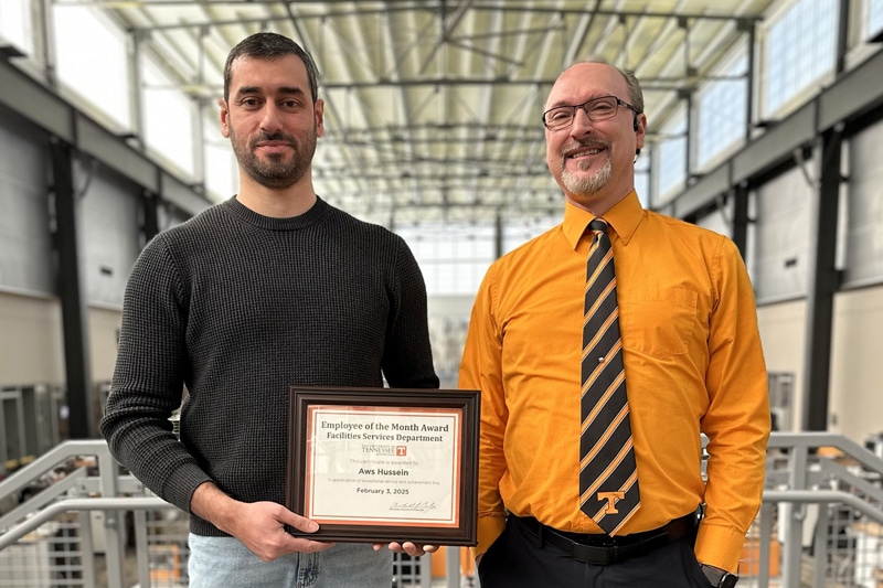 Pictured left to right: Facilities Services web designer Aws Hussein (Employee of the Month) poses with certificate and Kevin Garland, director of Communication and Information