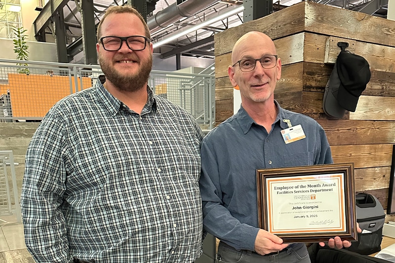 Pictured left to right: In-House construction director Bryan Lord and project manager John Giorgini poses with certificate