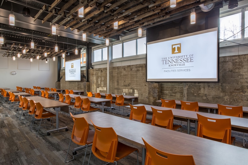 Facilities Services conference rooms 101 and 102 with tables and chairs and projector screens