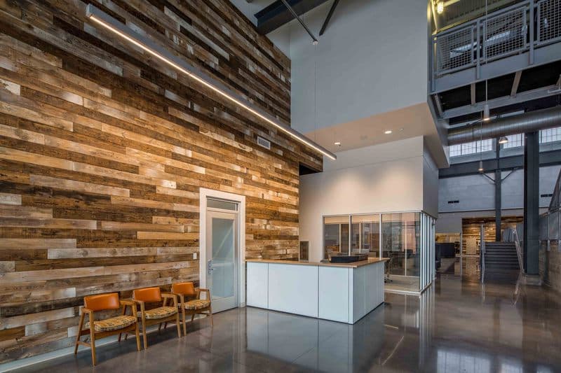 Facilities Services main entrance featuring wood paneling reclaimed from the roof