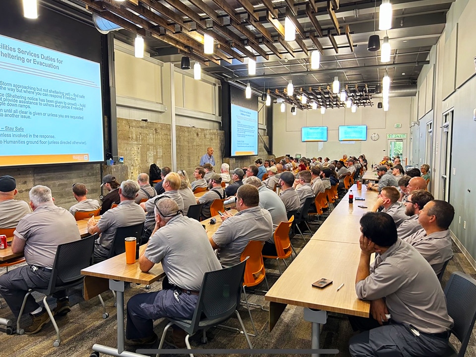 image of a full classroom of Facilities Services employees attending their annual football training