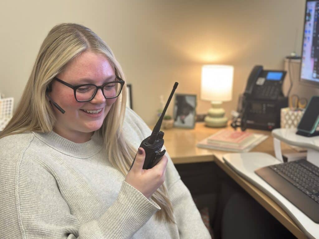 Work Order Management team member Allie McCosh radios in a call to Maintenance