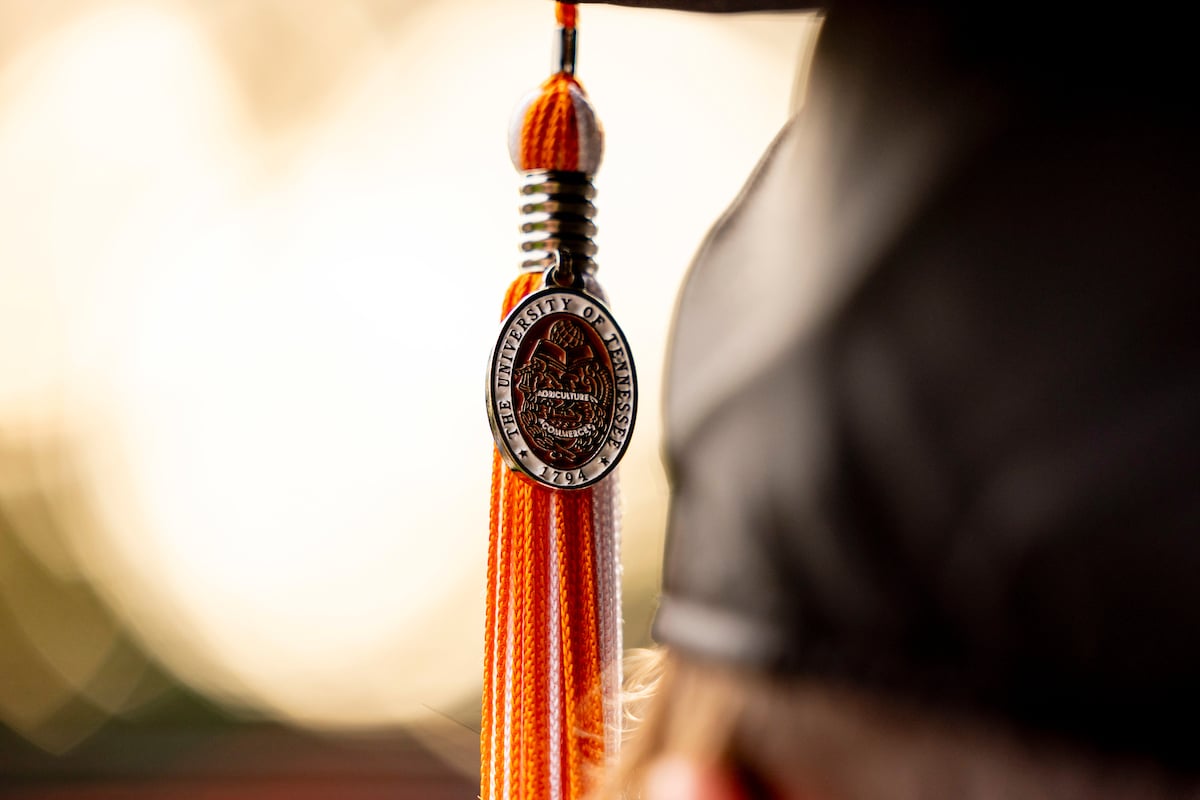 A graduate's tassel displays the University of Tennessee emblem