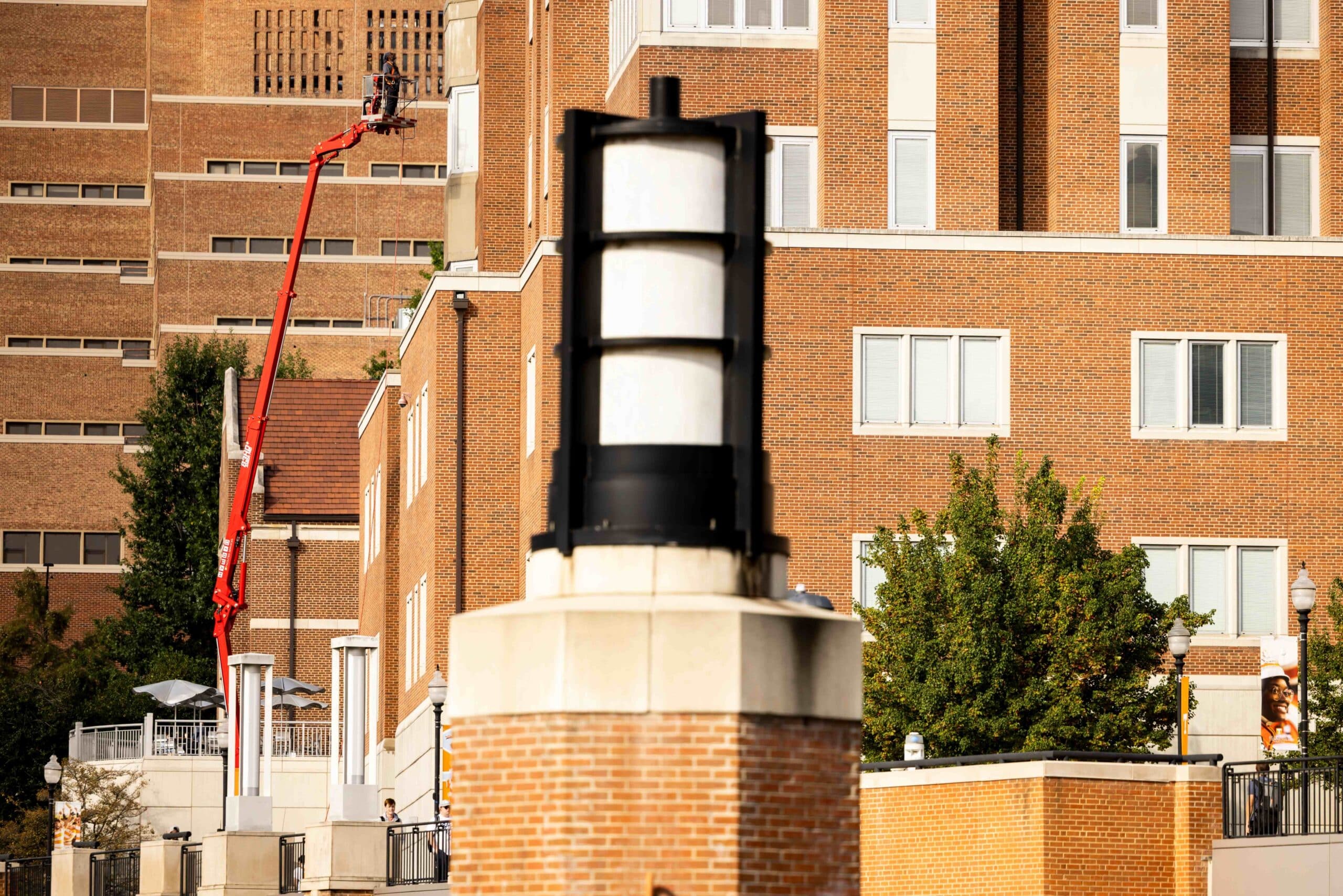 UT Facilities Services crew uses a pressure washer to clean the exterior brick at the Student Union