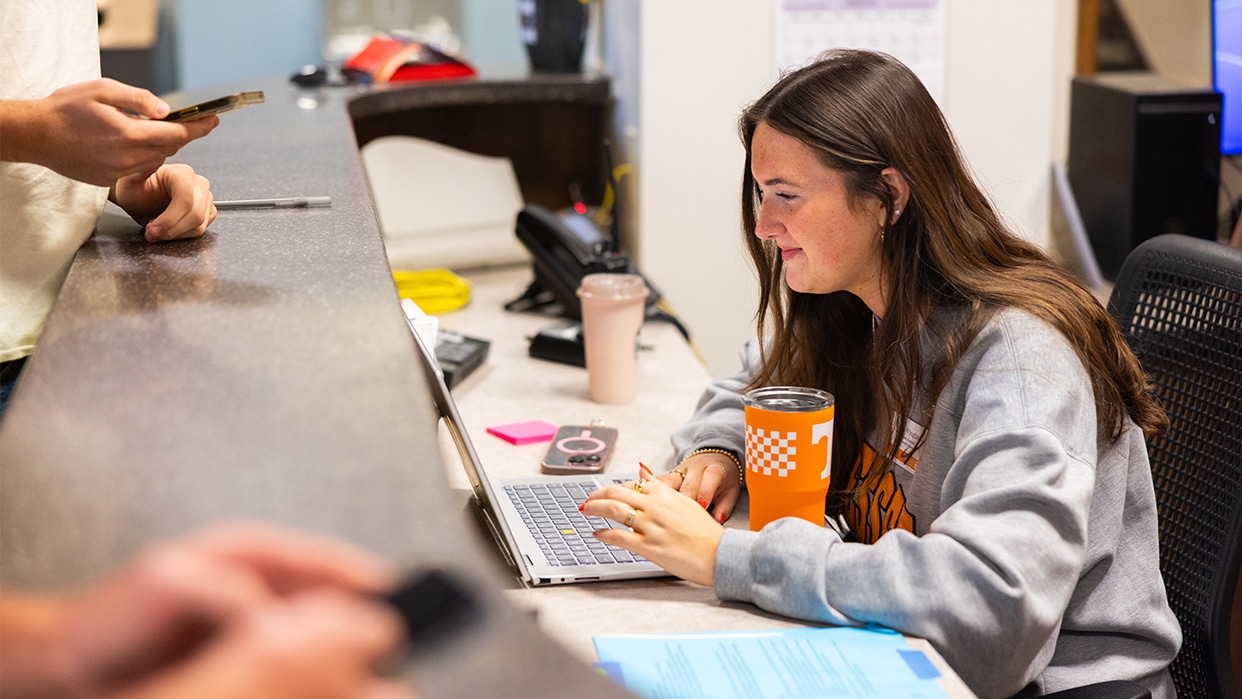 UT Employee helping students